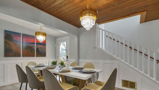 A dining area with a wooden ceiling, white walls, and a staircase. - Main House - Spacious Modern Retreat w/Wood Accents - Sleeps 12 (Vernon)