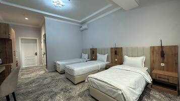Triple Room, City View | Desk, laptop workspace, blackout curtains, soundproofing