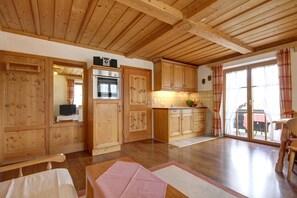 Eine geräumige Küche mit Holzausstattung und einem großen Fenster.