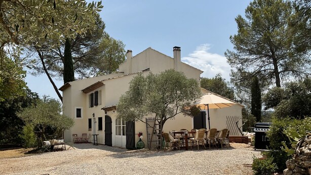 A two-story house with a gravel driveway, outdoor furniture, and a pergola. - LA CADENIERE by Interhome (Carces)