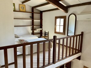 A bedroom with a bunk bed, a wooden chair, a window, and a mirror. - Les Valerianes by Interhome (Carces)