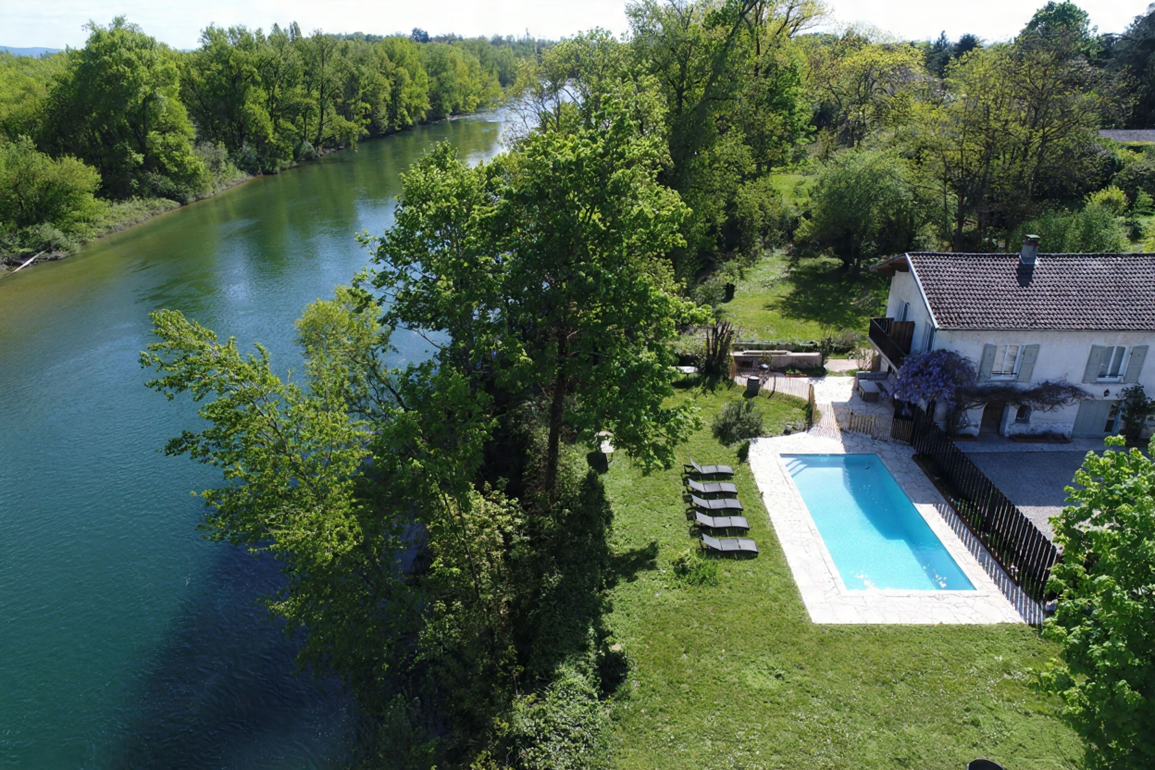 Una piscina al aire libre de temporada, sillones reclinables de piscina