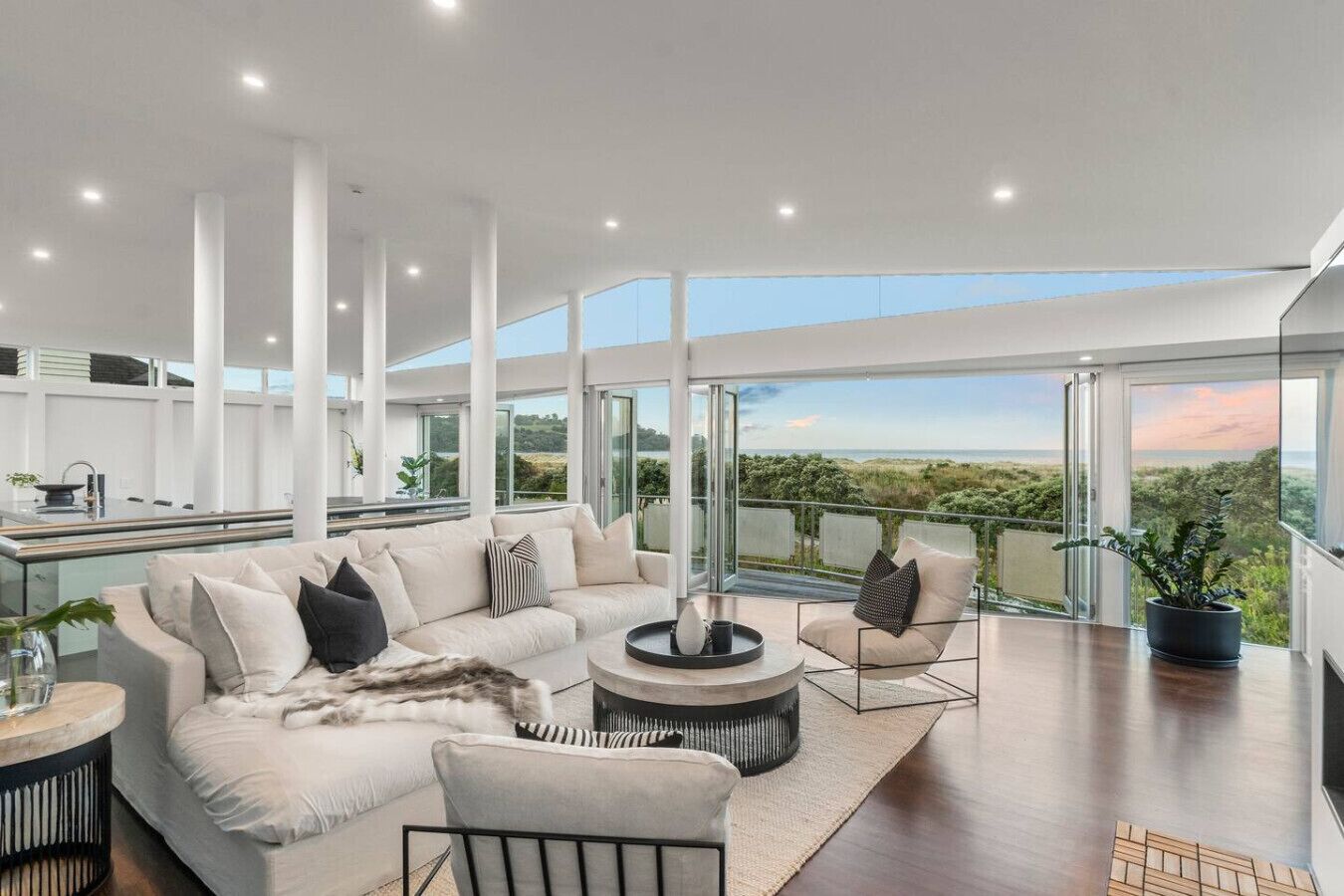 Spacious open plan living with gas fireplace for feeling cosy in winter, and bi-fold doors opening out to the deck overlooking the sand dunes for uninterrupted ocean views all year round.