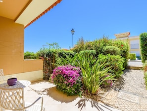 A courtyard with a pergola, a table with chairs, and a street lamp. - Vacation home  by Interhome (Lagos)