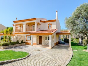 A two-story house with a stone facade, a tiled roof, and a paved driveway. - Casa Sunny Days - Boavista Resort by Interhome (Lagos)