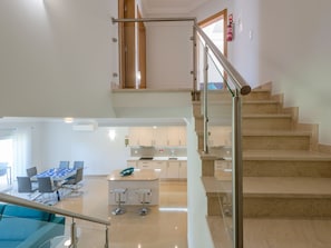 A modern interior with a staircase, a dining area, and a kitchen. - Vacation home  by Interhome (Lagos)