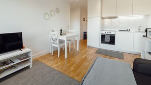 A modern apartment with a living room, dining area, and kitchen. - DOWNTOWN STYLISH APARTMENT & GARAGE by VACATIONY by Interhome (Porto)