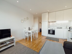 A modern apartment with a living room, dining area, and kitchen. - DOWNTOWN STYLISH APARTMENT & GARAGE by VACATIONY by Interhome (Porto)