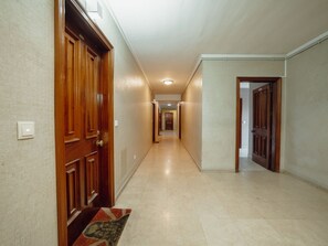 A hallway with wooden doors, a tiled floor, and a carpet runner at the entrance. - DOWNTOWN STYLISH APARTMENT & GARAGE by VACATIONY by Interhome (Porto)