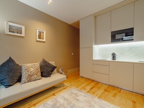 A modern kitchen with a built-in microwave and a small countertop. - Apartment  by Interhome (Porto)