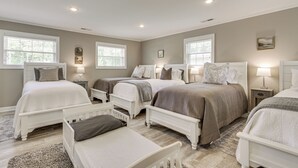 A bedroom with three beds, a bedside table with a lamp, and a window with blinds. - Shoals Area Oasis w/ Boat Dock & Outdoor Kitchen (Florence)