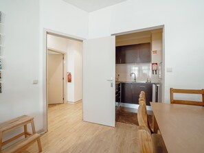 A compact kitchen with a sink, cabinets, and a fire extinguisher. - Apartment  by Interhome (Porto)