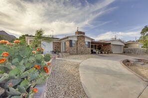 A residential house with a stone facade, a garage, and a patio area. - Mountain-View Haven: Home Near Fort Bliss (El Paso)