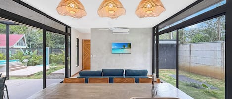 A modern kitchen with a large island, a built-in sink, and pendant lighting.