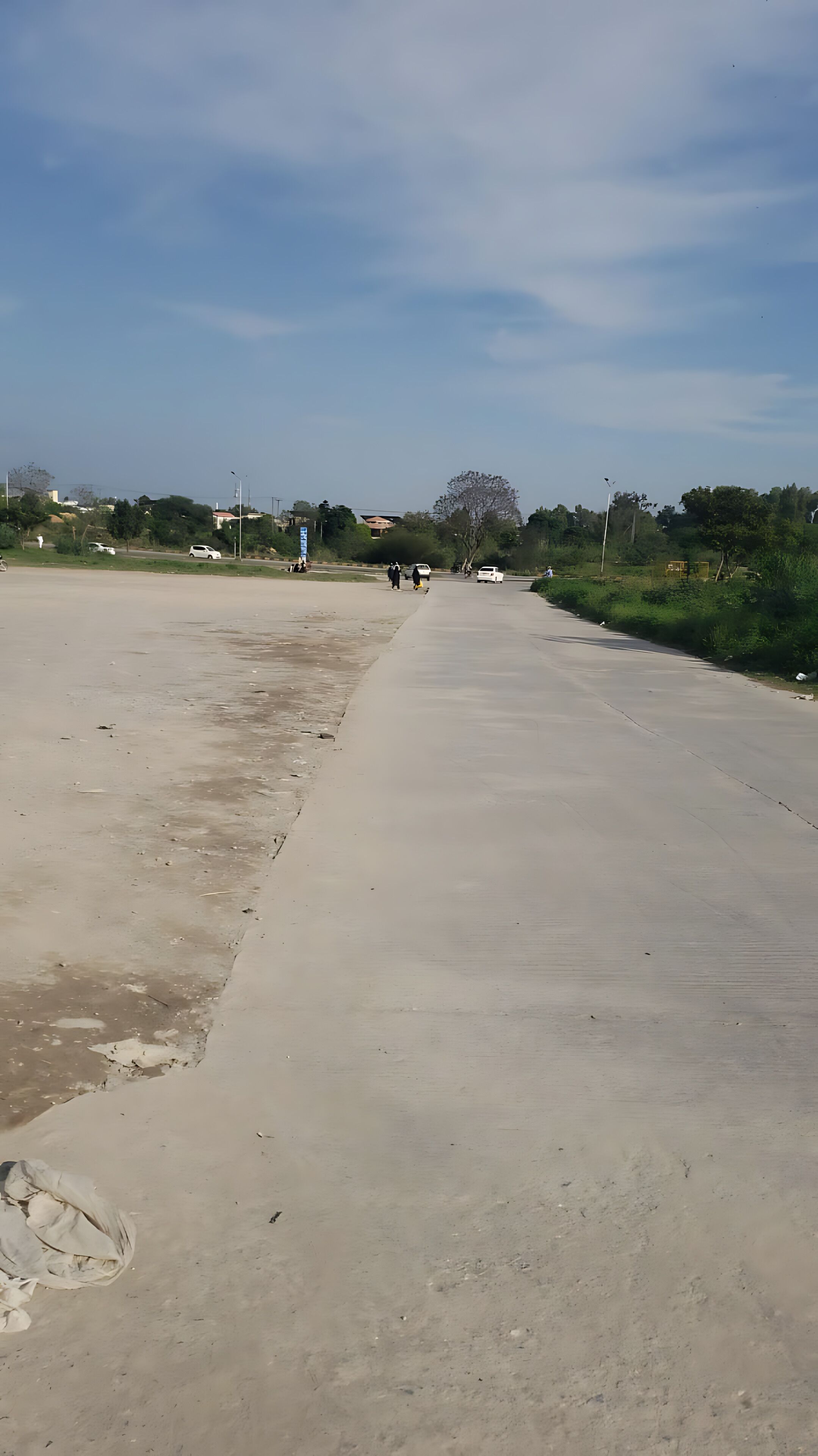 A wide, open concrete area with a clear sky.