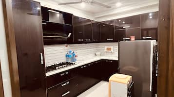 Fridge, stovetop, cookware/dishes/utensils, cleaning supplies
