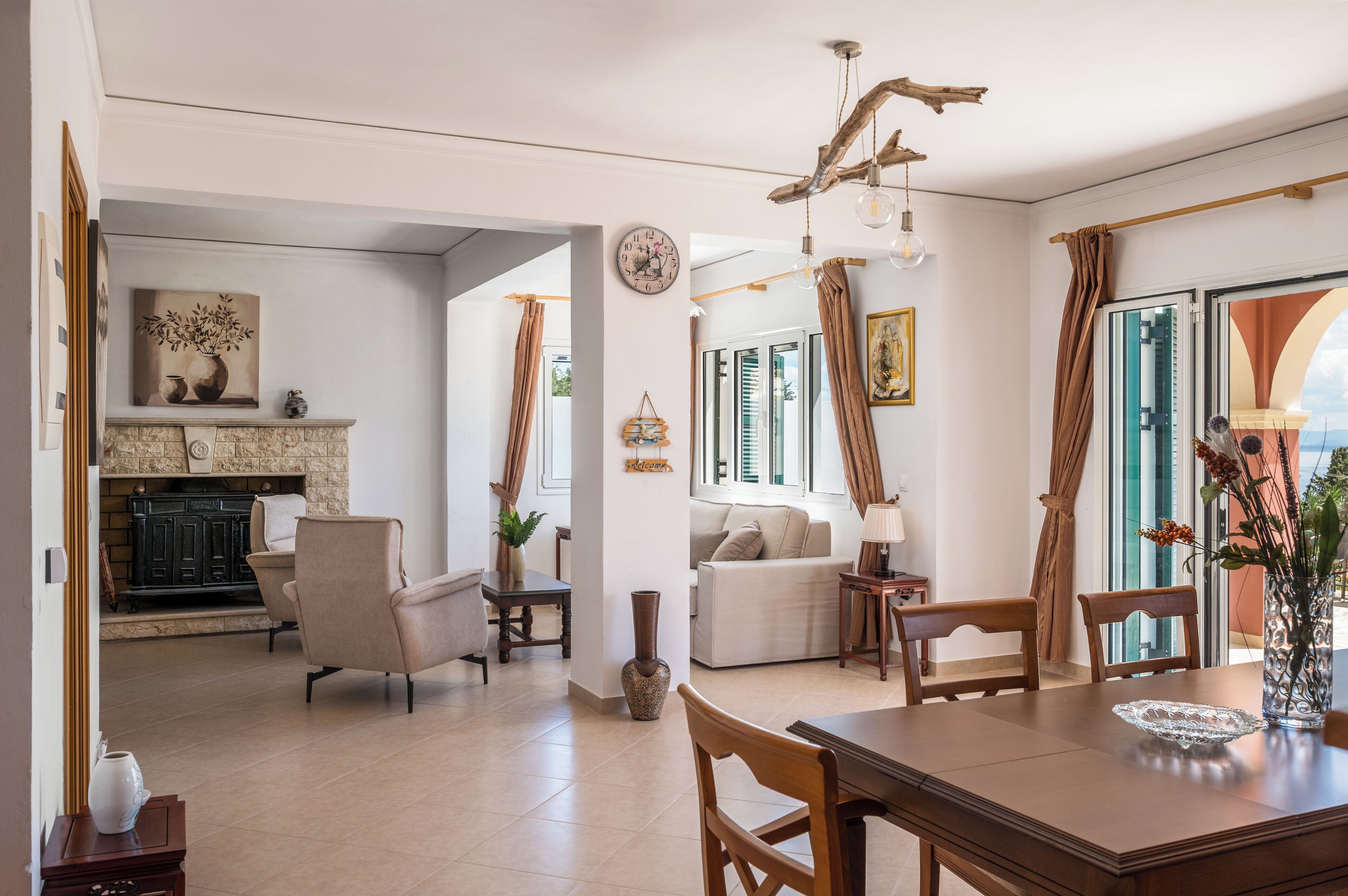 A spacious living area with a dining table, sofas, and a fireplace.