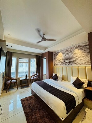 A hotel room with a bed, a desk, and a chair. - The Moonsoon Inn (Mussoorie)