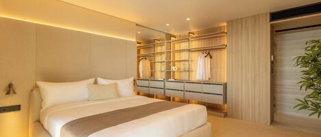 A modern bedroom with a large bed, built-in wardrobe, and a mirror.