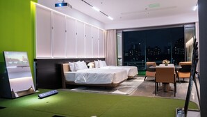 A modern hotel room with a large bed, a desk, and a balcony with a city view. - Golf Suite Hotel (Shenzhen)