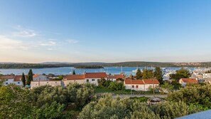 A coastal town with buildings, a marina, and a lake. - Sea View Apartment in Punat 1 by Villas Guide (Punat)