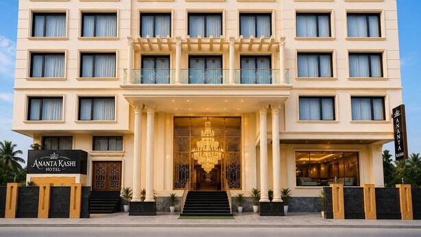 A multi-story hotel with a grand entrance, large windows, and a prominent chandelier. - ANANTA KASHI HOTEL (Varanasi)