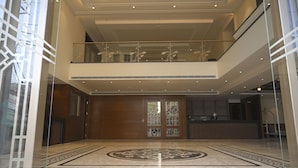 A spacious lobby with a high ceiling, a reception desk, and a patterned floor. - ANANTA KASHI HOTEL (Varanasi)