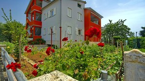 A two-story building with a modern architectural design, featuring balconies and large windows. - Coastal Serene Stay in Umag (Umag)