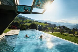 A swimming pool with a view of a mountainous landscape.
