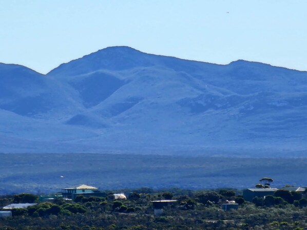 A mountainous landscape with buildings in the foreground.