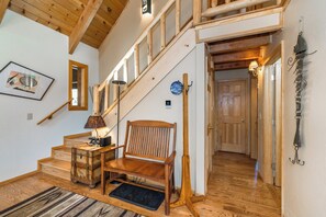 A wooden staircase with a bench, a framed picture, and a lamp on a side table. - Timberline Lodge_AC, Sauna, Shuffleboard (Truckee)