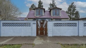 A two-story house with a metal gate and a number '257' on the wall. - Chama Crossing - Historic Home next to Railroad (Chama)