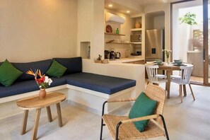 A modern living area with a sofa, a dining table, and a chair. - Boutique Ground Floor Apartment in La Punta *Starlink and Swimming Pool*. (La Barra de Colotepec)