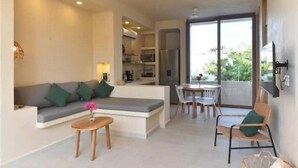 A modern living area with a sofa, coffee table, and dining set. - Apartment 1 Boutique in La Punta *Starlink | Swimming Pool*. (La Barra de Colotepec)