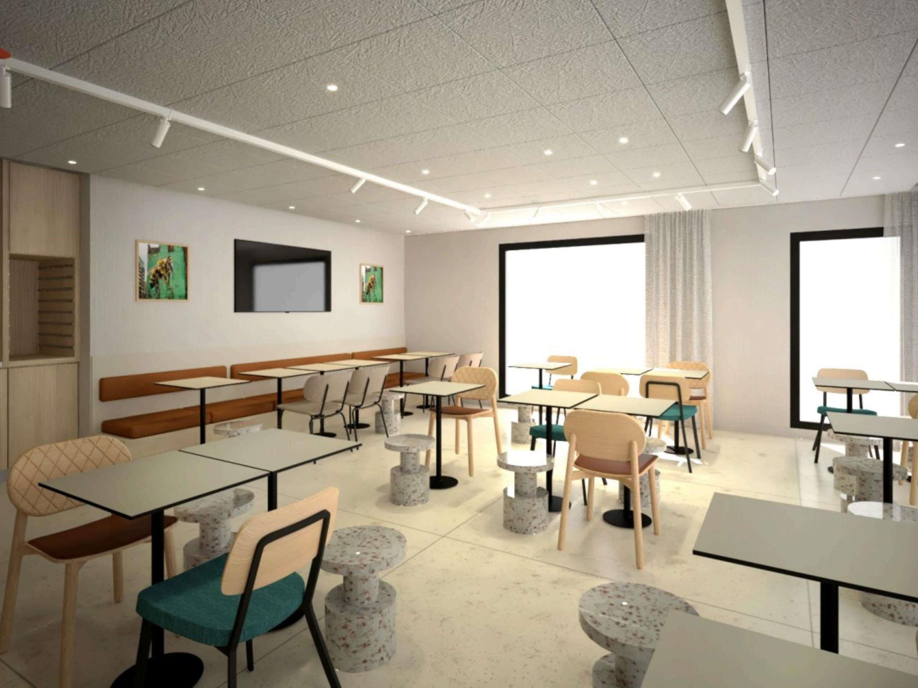A modern dining area with tables and chairs, a bench, and artwork on the walls.