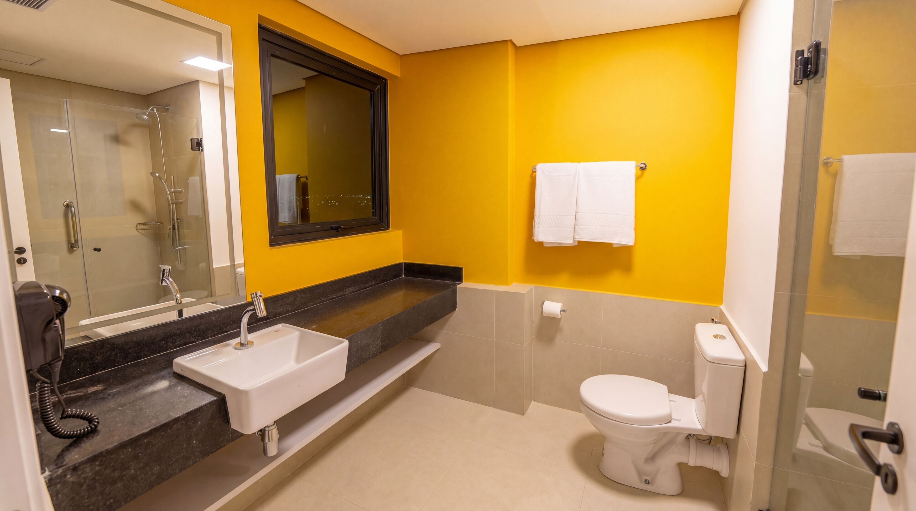 A bathroom with a shower, sink, and toilet.