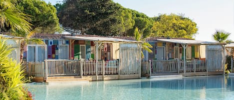 A row of mobile homes with a swimming pool in the foreground.