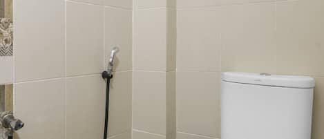 A bathroom with a toilet, a shower, and a towel rack.