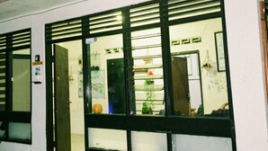 A building with large windows, a bench, and Coca-Cola crates outside.