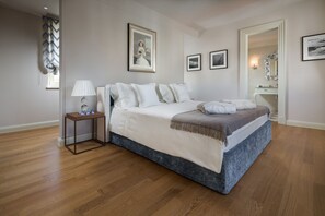 A bedroom with a bed, bedside table, lamp, framed pictures, and a mirror. - Villa Lea-casa del Sole Zadarvillas (Tar-Vabriga)