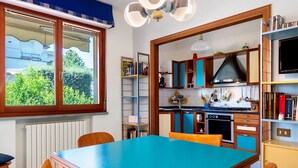 Una cocina con una mesa de comedor, sillas y vistas por la ventana.