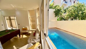 A poolside area with a pool, a billiards table, and a sofa. - Spacious 6-bedroom villa in gorgeous Tangier with pool (Tangier)