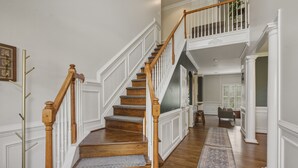 A staircase with wooden railings and carpeted steps leading to a second floor. - Spacious home in safe and accessible area! Close to Hull Street, TurnPike, & RVA (Midlothian)