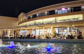 A multi-level building with outdoor seating areas and a water feature. - Host Prime Boutique hotel 25 (New Cairo)