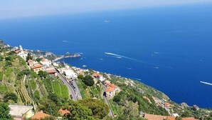 A coastal village with terraced houses, a winding road, and the sea in the background. - Al Chiar di Luna - Furore (Furore)