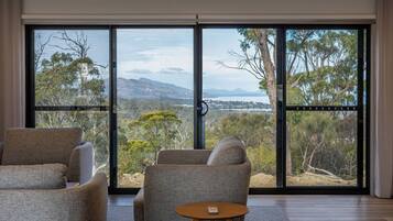 Deluxe House, Bay View | Living area | 43-inch Smart TV with digital channels, fireplace