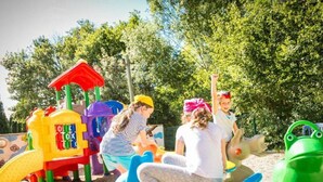 A playground with colorful play structures including a slide and a climbing frame. - Cozy chalet, pets welcome - 6 guests (Villegly)