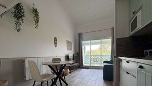 Een moderne keuken met een eethoek, uitzicht en een plafond met zichtbare balken.