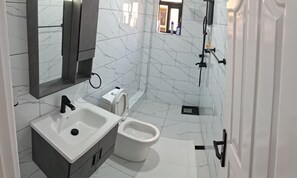 A modern bathroom with a sink, toilet, and shower. - Luxurious 3-bedroom apartment in Nairobi, Athi River (Athi River)