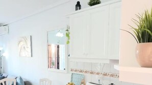 A compact kitchen with a washing machine, a sink, and a countertop.